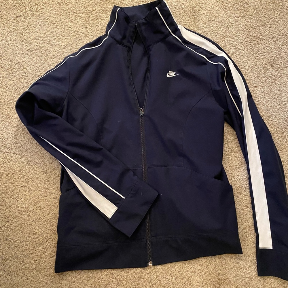 Navy Blue Woman’s Nike sports zip up jacket.